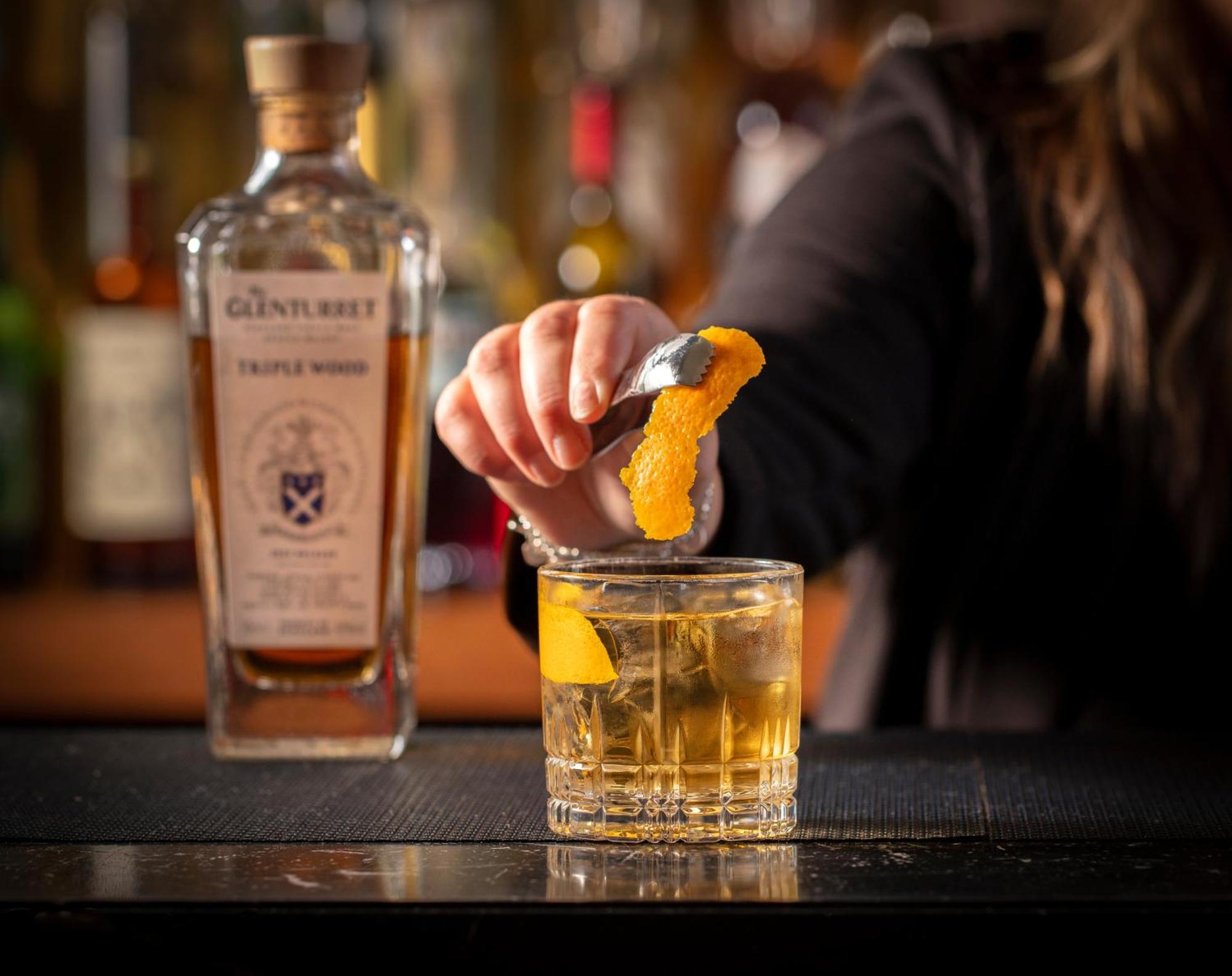 Schloss Roxburghe, Part Of Destination By Hyatt Exteriér fotografie A bartender adding a lemon twist to a glass of GINfinity